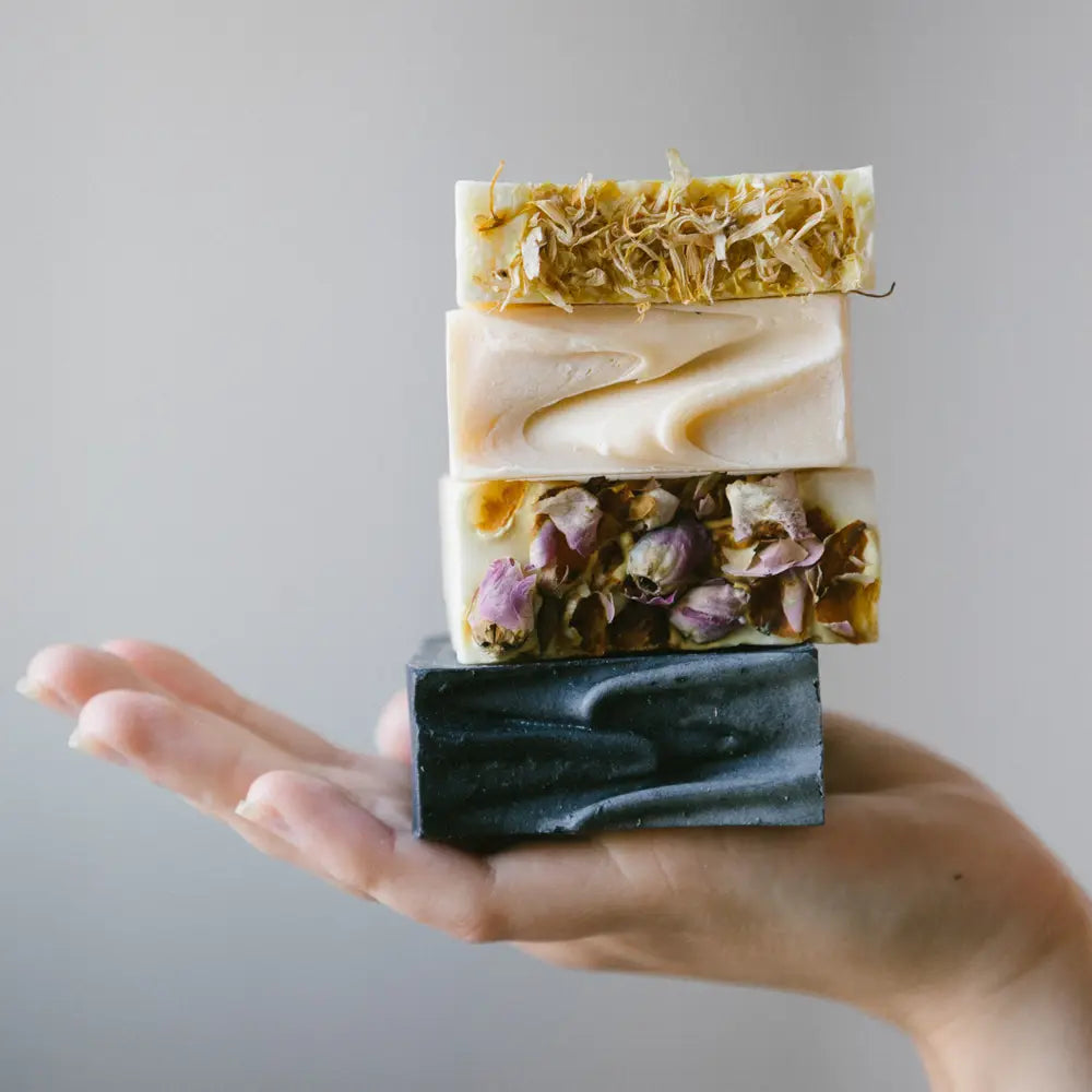 lady hand holding me time soap bars with light grey background