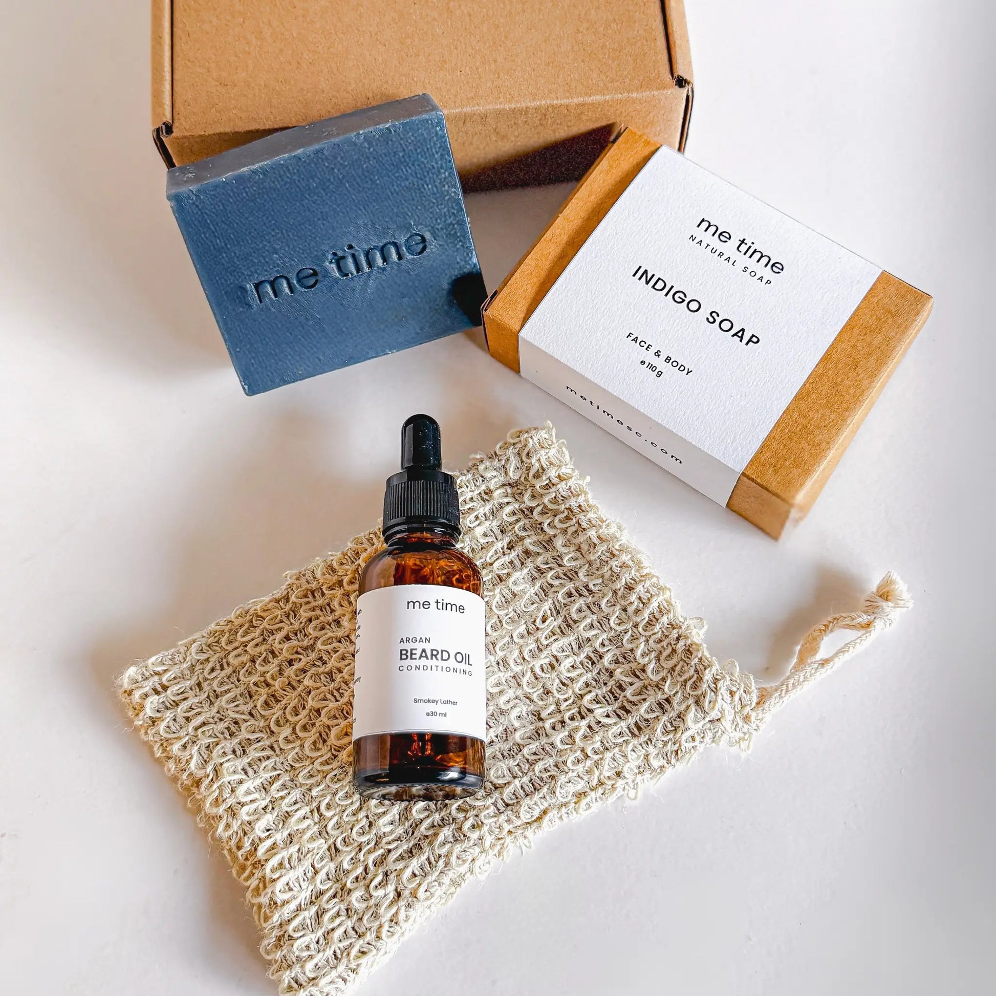 The Ultimate Self-Care Kit for Him – A luxurious men's grooming gift set featuring handcrafted Indigo Artisan Soap, Argan Conditioning Beard Oil, and an Exfoliating Soap Pouch. 100% natural, eco-friendly, and designed for deep hydration, nourishment, and relaxation