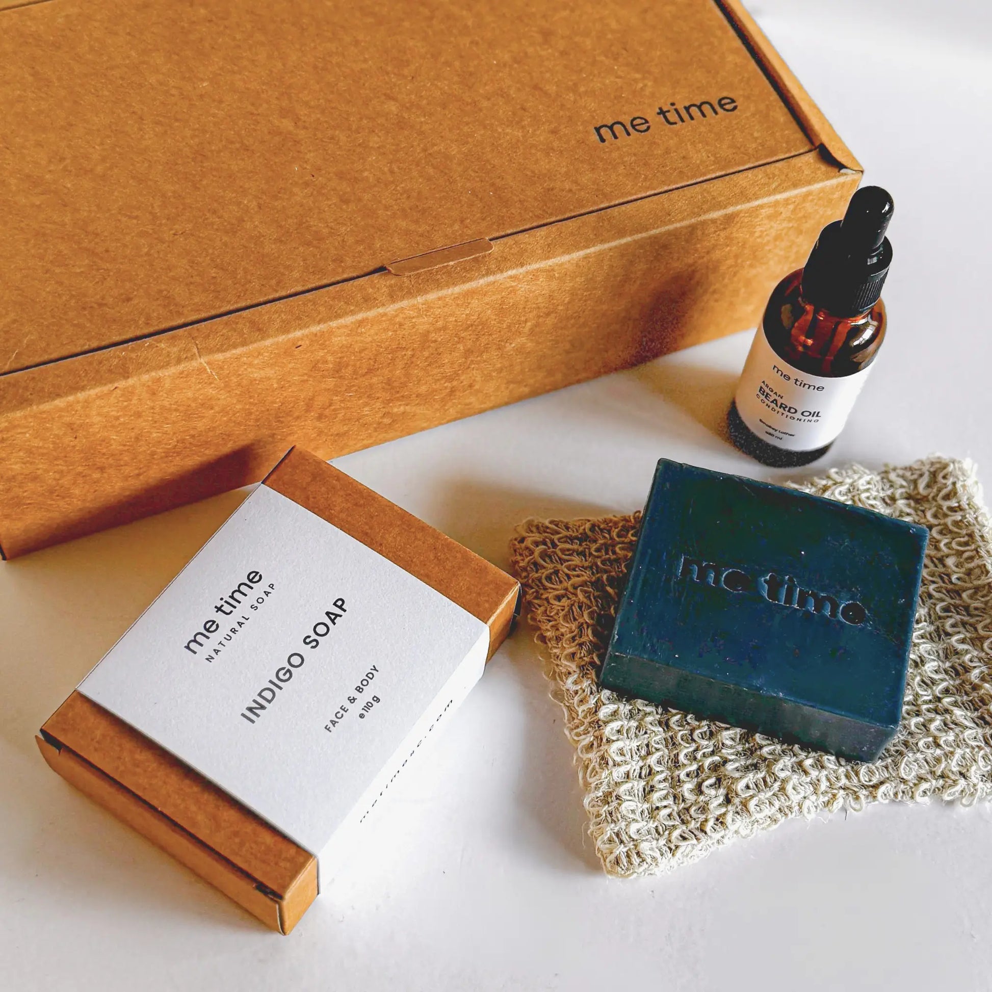 The Ultimate Self-Care Kit for Him – A luxurious men's grooming gift set featuring handcrafted Indigo Artisan Soap, Argan Conditioning Beard Oil, and an Exfoliating Soap Pouch. 100% natural, eco-friendly, and designed for deep hydration, nourishment, and relaxation